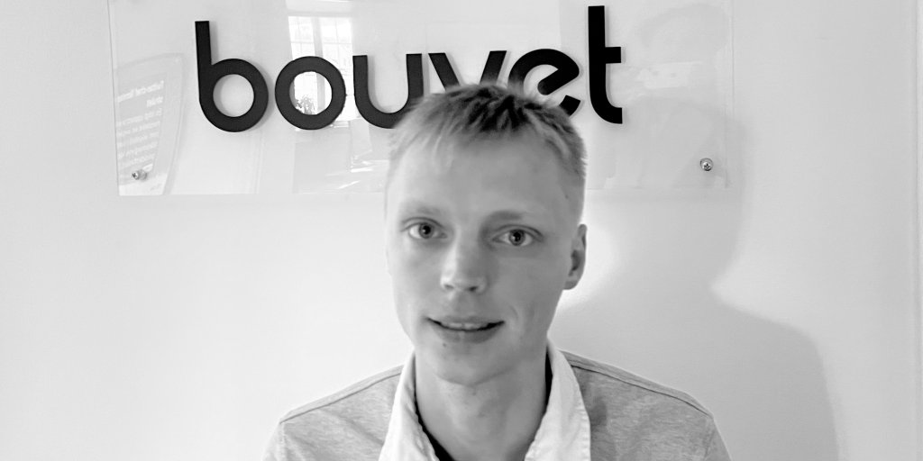 Porträttbild på Dennis Olsson med Bouvets logga i bakgrunden